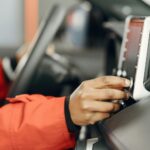 person adjusting monitor glare